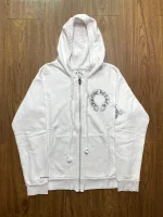 Chrome Hearts is a luxury fashion brand that was founded in 1988 by Richard Stark and his wife Laurie Lynn Stark. The brand is known for its high-end jewelry, leather goods, and clothing, including the Chrome Hearts Cross Logo Hollywood USA Zip Hoodie. The hoodie is made of premium materials and features the Chrome Hearts logo on the front and back. It is a popular item among fans of the brand and is often sought after for its quality and style.