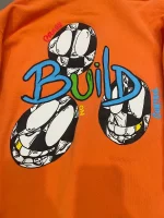 The Chrome Hearts Orange Matty Boy Link and Build Hoodie is a limited edition hoodie produced by the high-end fashion brand Chrome Hearts. It likely features a unique design and is made of high-quality materials. As a language model, I do not have access to the internet and cannot verify the authenticity of this specific item or provide any further information about it. My knowledge is based on information that was available prior to 2021, and I do not have access to current information or the ability to browse the web.