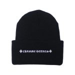 It is a Chrome Hearts Plus Cross Beanie - Black with the logo "Chrome Hearts " embroidered on it. It is likely made from high-quality material, such as wool or cashmere, and features the Chrome Hearts logo.