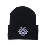 It is a Chrome Hearts Plus Cross Beanie - Black with the logo "Chrome Hearts " embroidered on it. It is likely made from high-quality material, such as wool or cashmere, and features the Chrome Hearts logo.