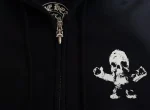 The Chrome Hearts Foti Skeleton Circle Logo Zip Up Hoodie is a limited edition item from the high-end fashion brand Chrome Hearts. It features the Chrome Hearts Foti skeleton circle logo on the front and a zip-up front. This hoodie is made of black cotton and is no longer in production, making it rare and potentially difficult to find. It may be available on resale sites or through private collectors. Chrome Hearts is known for its luxury jewelry and accessories, as well as its clothing line. Its items are highly sought after by collectors and fashion enthusiasts.