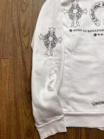 Chrome Hearts is a luxury fashion brand that was founded in 1988 by Richard Stark and his wife Laurie Lynn Stark. The brand is known for its high-end jewelry, leather goods, and clothing, including the Chrome Hearts Cross Logo Hollywood USA Zip Hoodie. The hoodie is made of premium materials and features the Chrome Hearts logo on the front and back. It is a popular item among fans of the brand and is often sought after for its quality and style.